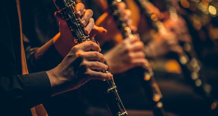 A close up of a group playing clarinet