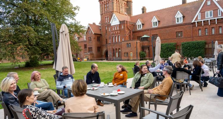 Terrace with guests and College building in the background