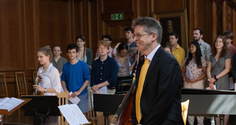 Dr Gareth Wilson in Great Hall with the Girton College Chapel Choir