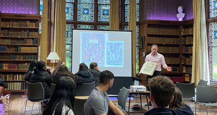 Seb Falk talking to students in the Stanley Library, Girton College