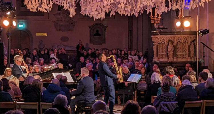 Performing on saxophone, the Rev’d Dr Boniface in a concert